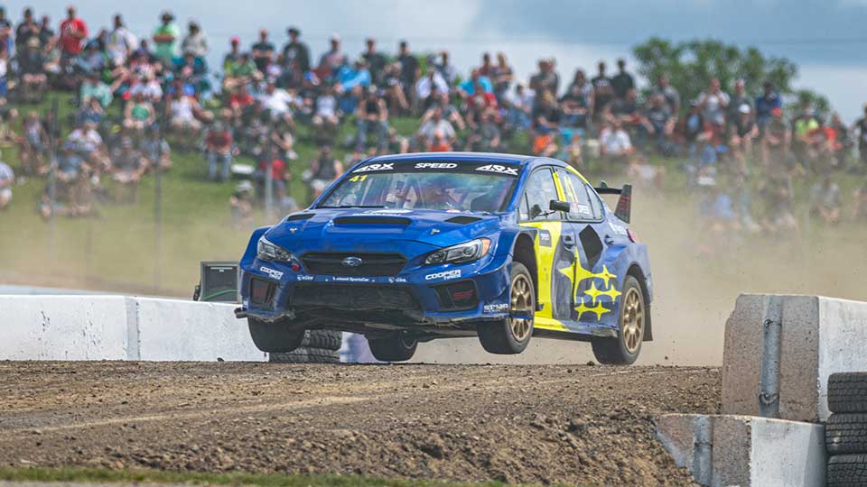 Scott Speed goes over the jump at Mid-Ohio