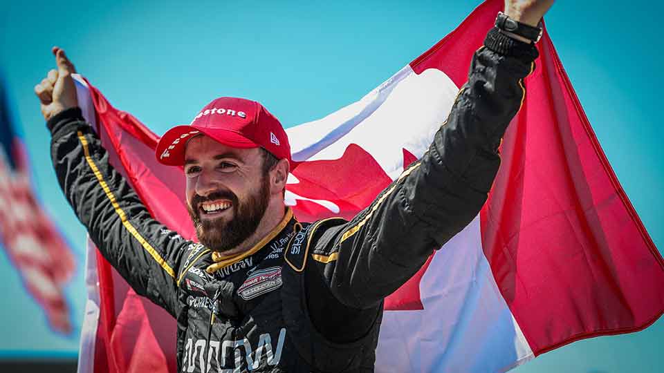 James Hinchcliffe holds the Canadian Flag